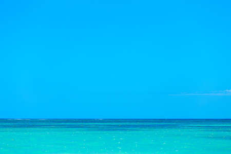 Simple background of turquoise blue sea water and clear blue skyの写真素材