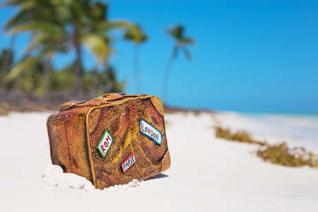 Travel suitcase toy on the beachの写真素材