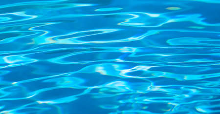 Abstract blue water texture on swimming pool surfaceの写真素材