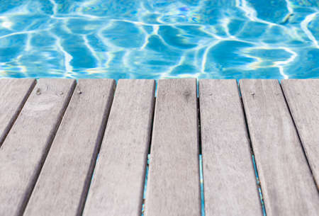 Empty wooden deck by the swimming poolの写真素材