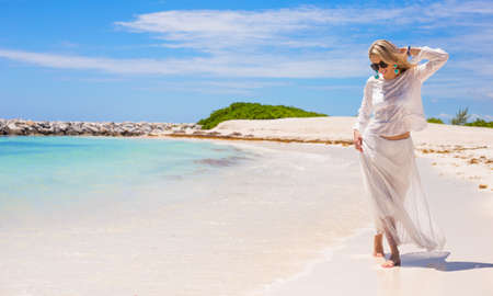 Young happy woman walking on the beachの写真素材