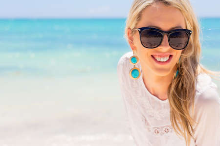 Young happy woman enjoying vacation on tropical beachの写真素材