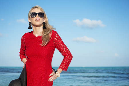 Fashionable young woman in red dressの写真素材