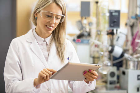 Chemist using tablet computer in the labの写真素材