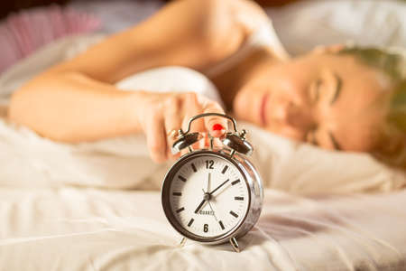 Happy woman waking up in morningの写真素材