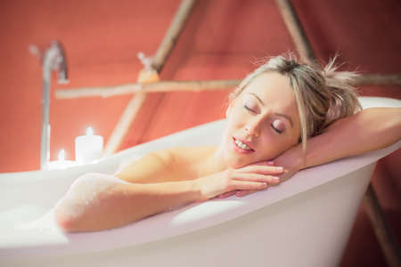 Young woman enjoying bathの写真素材