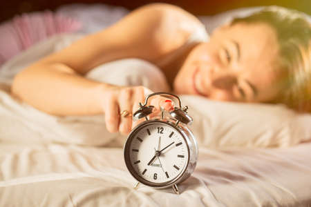 Happy woman waking up in morningの写真素材