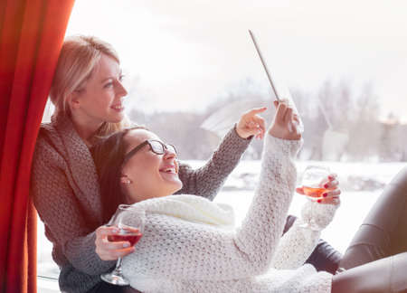 Two female friends looking at tablet computerの写真素材