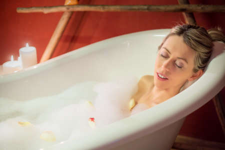 Young woman enjoying bathの写真素材