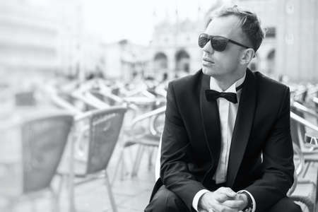 Black and white photo of young handsome man in tuxedoの写真素材