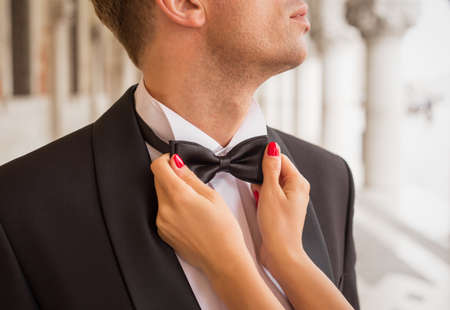 Lady fixing man's bow tieの写真素材