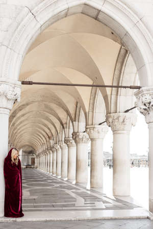 Mysterious woman in red cloakの写真素材