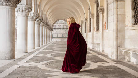 Mysterious woman in red cloakの写真素材