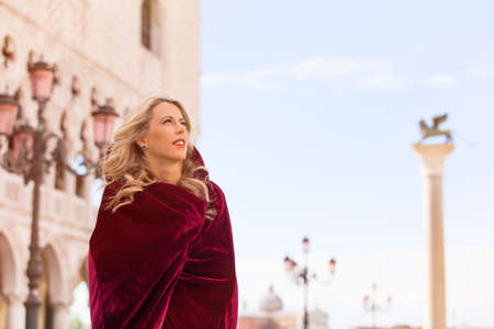 Portrait of mysterious woman in red cloakの写真素材
