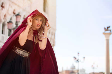 Mysterious woman in red cloakの写真素材