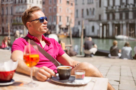 Handsome man sitting in outdoor cafeの写真素材