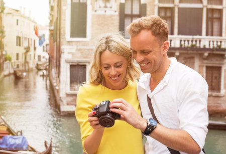Tourists in Venice looking at pictures on digital camera