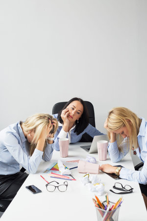 Exhausted women in the officeの写真素材