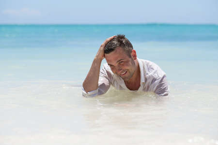 Handsome man in wet shirtの写真素材