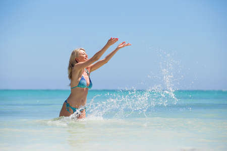 Cheerful woman having fun in the oceanの写真素材