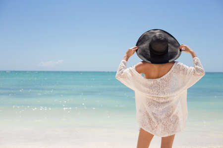 Woman enjoying holidays on the beachの写真素材
