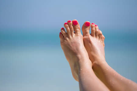 Bare woman's feet on the beachの写真素材