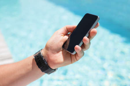 Man holding smartphone in handの写真素材