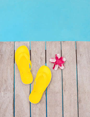 Yellow flip flops by the poolの写真素材