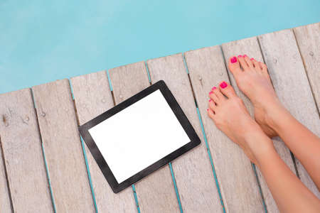 Using digital tablet on vacationの写真素材