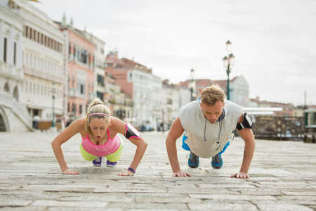 Couple exercising and doing push-ups togetherの写真素材