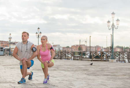 Couple stretching before workout in the cityの写真素材
