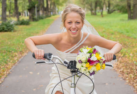 Bride riding a bicycleの写真素材