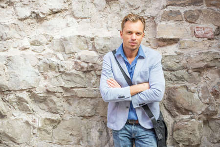 Man standing by the rock wallの写真素材