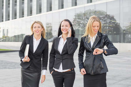 Three business women using modern technologyの写真素材