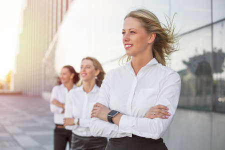 Successful women looking into future with their hands crossedの写真素材