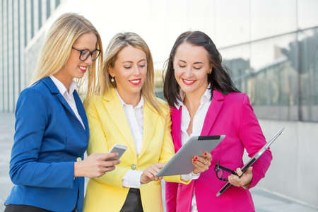 Smart business women looking at tabletの写真素材