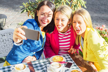 Three friends taking a  picture of themselvesの写真素材