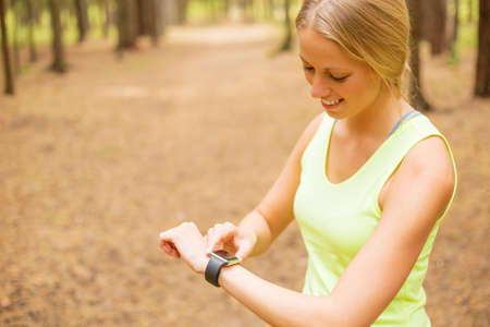 Woman monitoring her pulse on smartwatchの写真素材