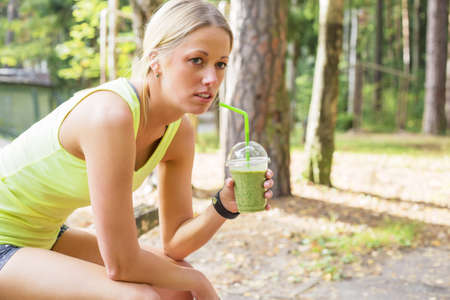 Woman after workout drinking smoothieの写真素材