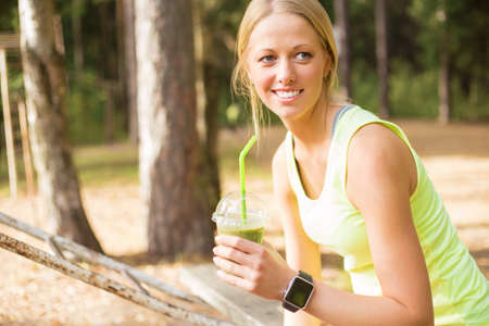 Healthy and young woman drinking smoothieの写真素材