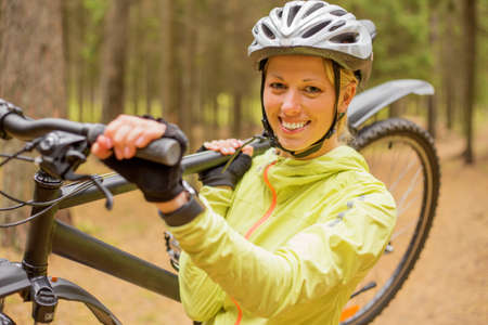 Woman carrying bicycleの写真素材