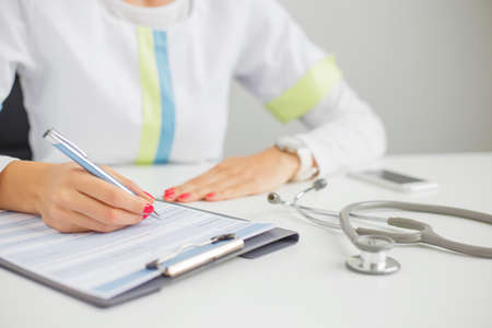 Doctor signing documentsの写真素材