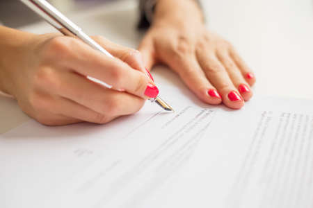 Female writing on paperの写真素材