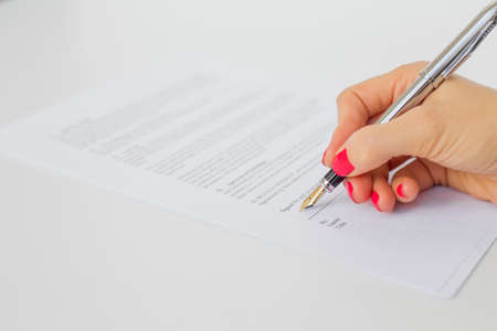 Woman signing papersの写真素材