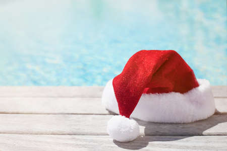 Red Christmas hat sitting by the poolの写真素材