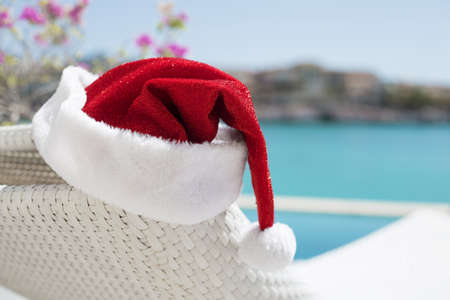 Red Christmas hat by the poolの写真素材