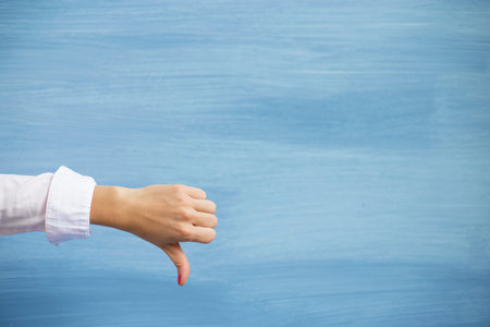 Female showing thumbs downの写真素材