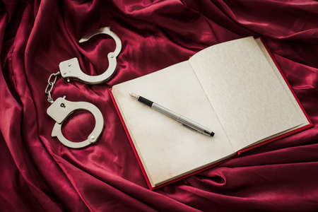 Notebook and handcuffsの写真素材