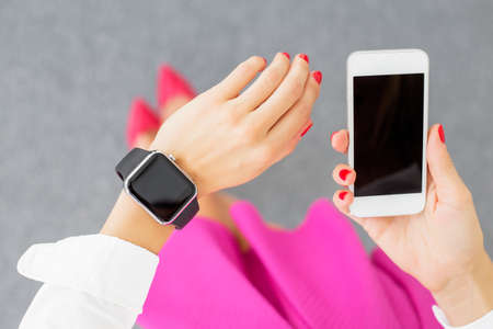 Woman using smartwatch and smartphoneの写真素材