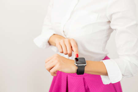Female with smartwatch on her wristの写真素材